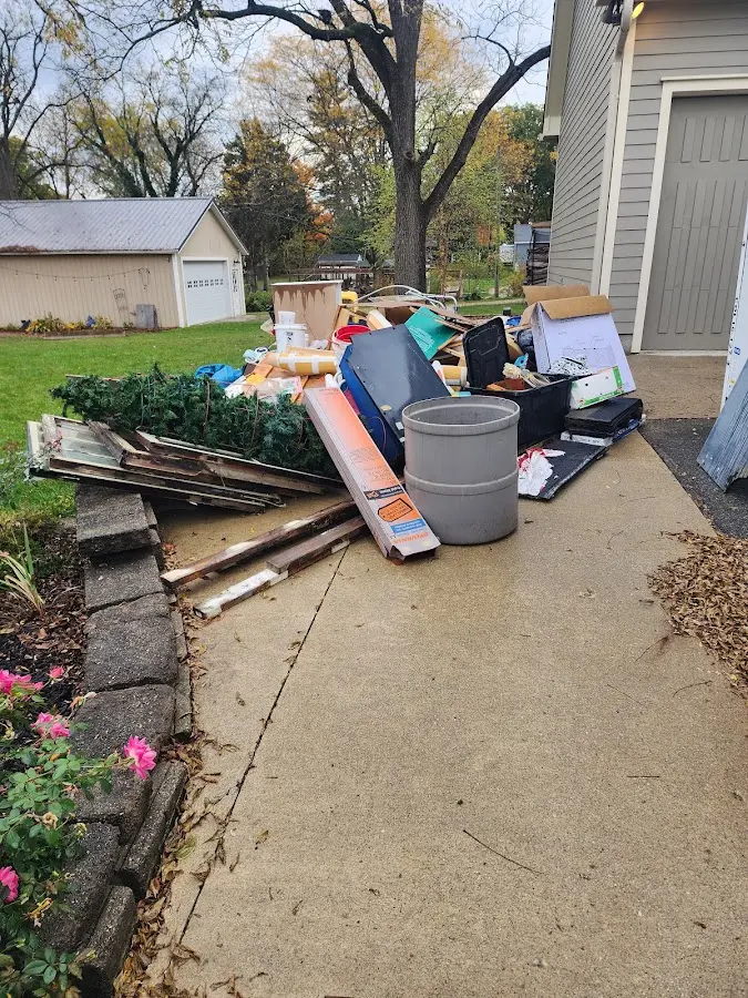 Dumpster being loaded with debris for Demolition Dumpster Rental in Minot